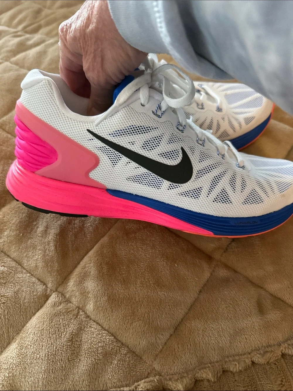 Nike Women's White Running Shoes with Blue and Pink Accents